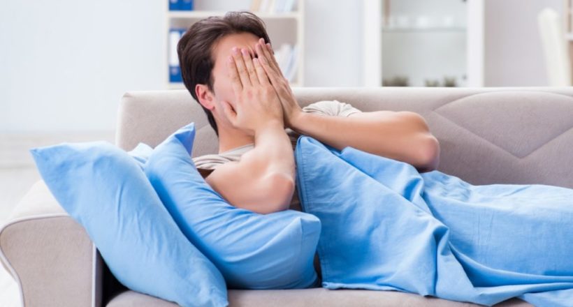 Man suffering from insonmia in bed at home